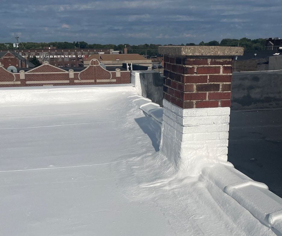 Foam sprayed along edges and corners to improve roof drainage.